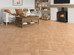 Living room with wooden flooring, sofa, coffee table, and fireplace.